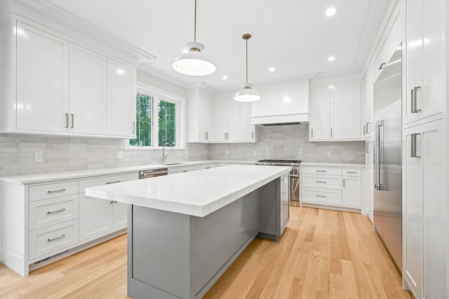 28 Pin Oak Ct, Westport, CT 06880 - kitchen featuring premium appliances, light wood-style floors, white cabinetry, crown molding, and recessed lighting