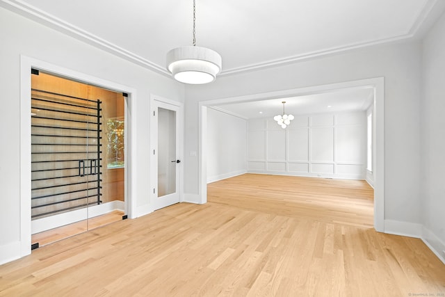 28 Pin Oak Ct, Westport, CT 06880 - unfurnished room with light wood-style floors and a chandelier