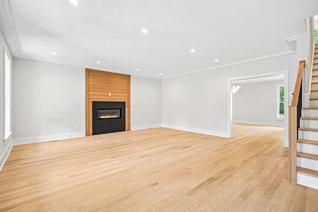 28 Pin Oak Ct, Westport, CT 06880 - unfurnished living room featuring stairway, a fireplace, recessed lighting, light wood-style flooring, and crown molding