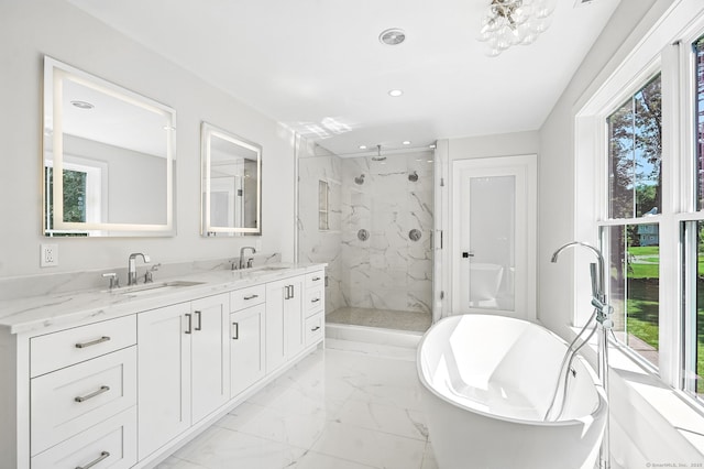 28 Pin Oak Ct, Westport, CT 06880 - bathroom with a marble finish shower, marble look tiles, double vanity, a freestanding tub, and recessed lighting