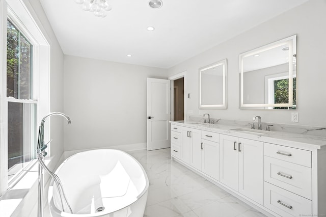 28 Pin Oak Ct, Westport, CT 06880 - full bathroom featuring marble look tiles, double vanity, a freestanding bath, and recessed lighting