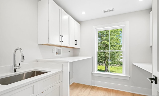 28 Pin Oak Ct, Westport, CT 06880 - kitchen featuring white cabinets, light wood-style flooring, light countertops, and recessed lighting