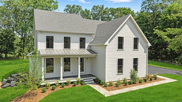 28 Pin Oak Ct, Westport, CT 06880 - modern inspired farmhouse with covered porch, a front lawn, a standing seam roof, roof with shingles, and a metal roof