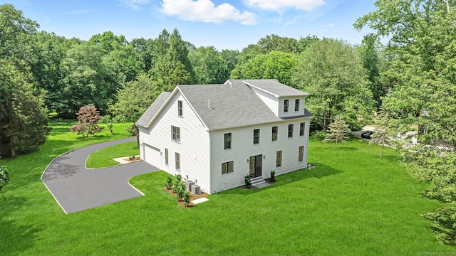 28 Pin Oak Ct, Westport, CT 06880 - view of side of property with roof with shingles, a yard, entry steps, and a wooded view