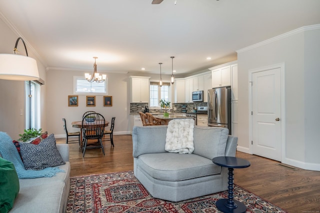 21 Hendricks Ln, Simsbury, CT 06070 - living room featuring ornamental molding, dark wood-style floors, a chandelier, recessed lighting, and ceiling fan