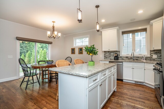 21 Hendricks Ln, Simsbury, CT 06070 - kitchen with stainless steel appliances, crown molding, backsplash, a kitchen island, and a chandelier