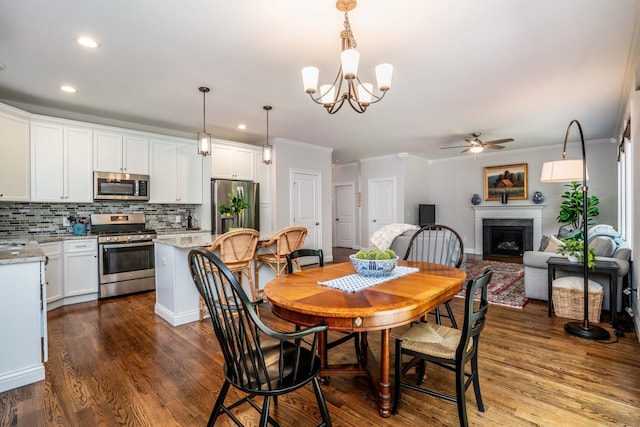 21 Hendricks Ln, Simsbury, CT 06070 - dining area with a ceiling fan, ornamental molding, recessed lighting, a fireplace, and dark wood-type flooring