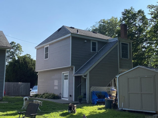28 Union St, Plymouth, CT 06786 - rear view of property featuring a shed, a chimney, and a shingled roof