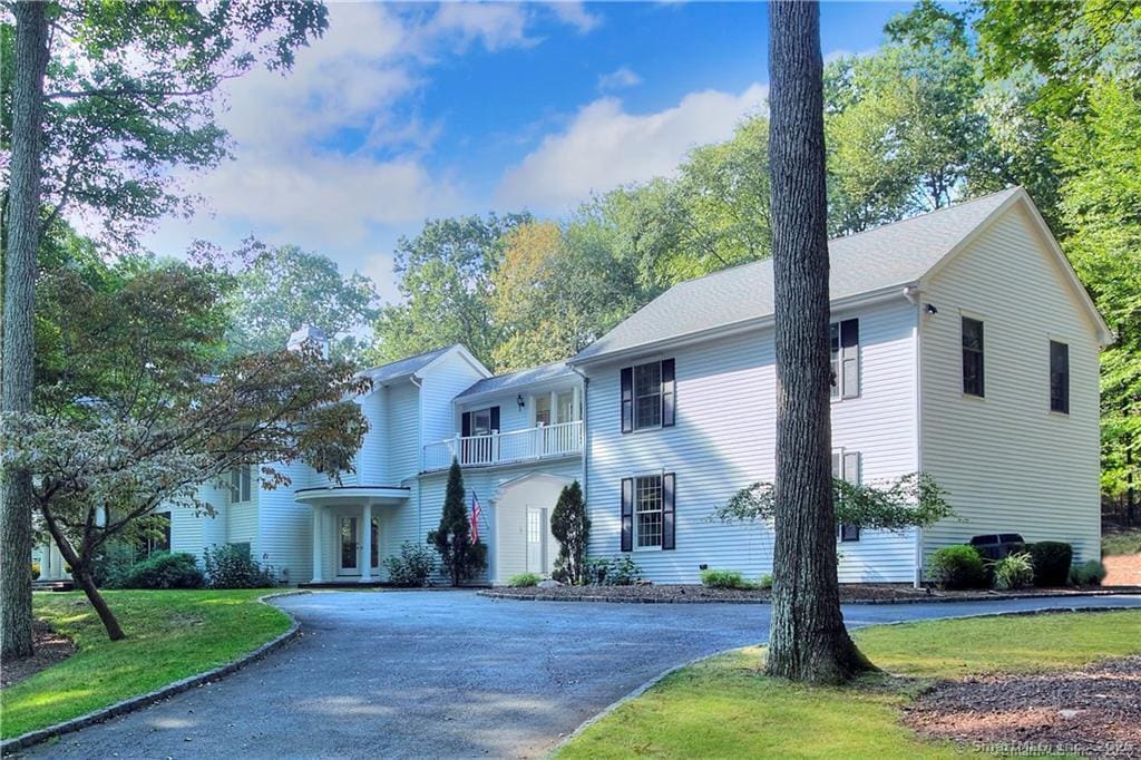 101 Brambley Hedge Cir, Fairfield, CT 06824 - view of front of property with curved driveway, a balcony, and a front yard