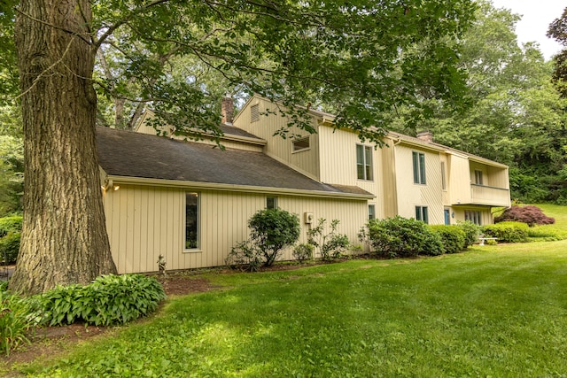 472 Saw Mill Rd, Guilford, CT 06437 - view of property exterior with a chimney, a yard, and a shingled roof