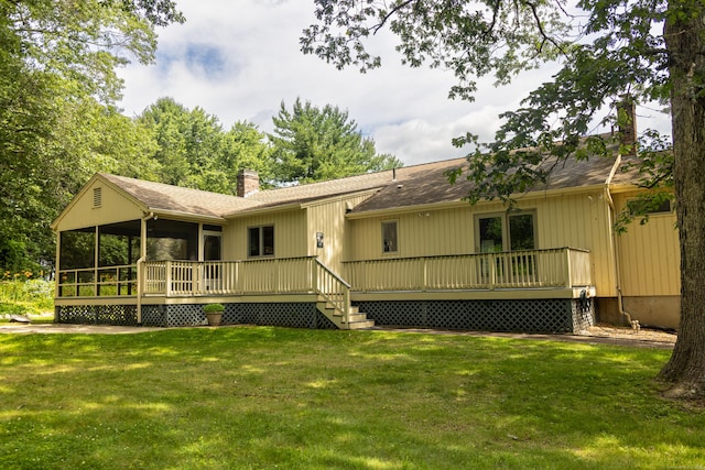472 Saw Mill Rd, Guilford, CT 06437 - back of house featuring a chimney, a sunroom, a wooden deck, and a lawn