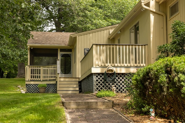 472 Saw Mill Rd, Guilford, CT 06437 - view of exterior entry featuring roof with shingles, a lawn, and a deck