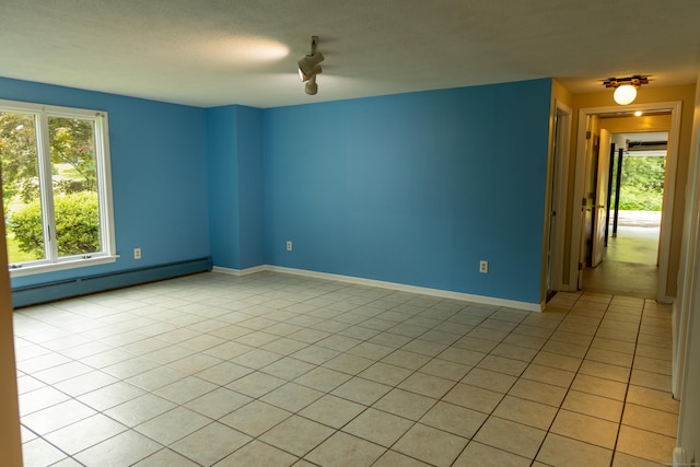 472 Saw Mill Rd, Guilford, CT 06437 - unfurnished room featuring a baseboard heating unit, healthy amount of natural light, and light tile patterned flooring