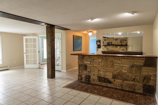 472 Saw Mill Rd, Guilford, CT 06437 - bar area with tile patterned floors, a textured ceiling, healthy amount of natural light, and a baseboard radiator