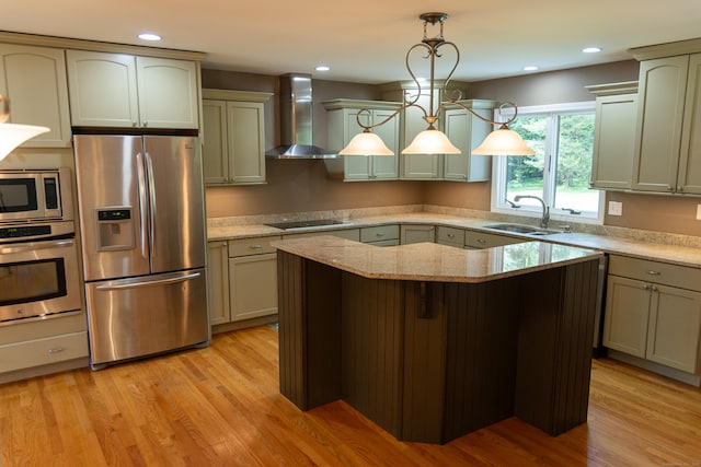 472 Saw Mill Rd, Guilford, CT 06437 - kitchen featuring stainless steel appliances, wall chimney exhaust hood, a center island, light stone counters, and decorative light fixtures