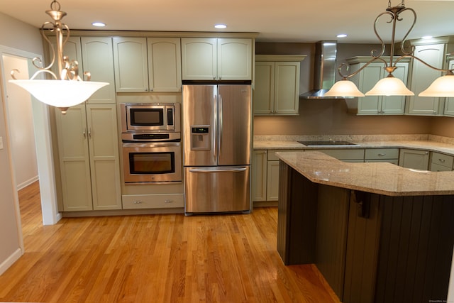 472 Saw Mill Rd, Guilford, CT 06437 - kitchen featuring appliances with stainless steel finishes, wall chimney range hood, light wood finished floors, light stone counters, and pendant lighting