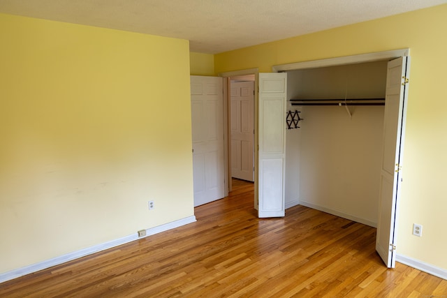 472 Saw Mill Rd, Guilford, CT 06437 - unfurnished bedroom featuring light wood-type flooring and a closet