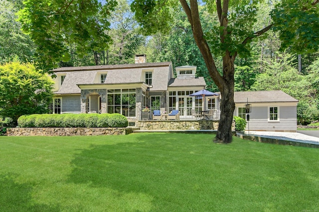 66 Little Brook Rd, Wilton, CT 06897 - rear view of house featuring a sunroom, a chimney, and a yard