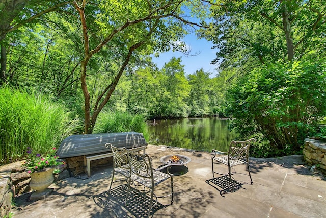 66 Little Brook Rd, Wilton, CT 06897 - view of patio featuring an outdoor fire pit, a water view, and a forest view