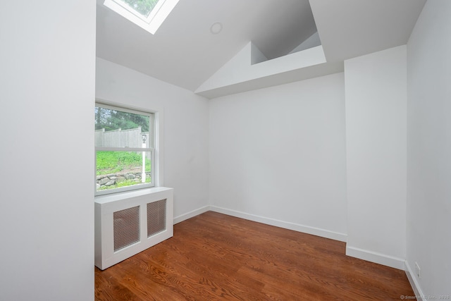 254 W Ave, Darien, CT 06820 - spare room with radiator, vaulted ceiling, a skylight, and wood finished floors