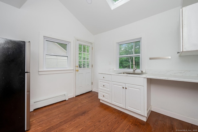 254 W Ave, Darien, CT 06820 - kitchen with a baseboard radiator, freestanding refrigerator, vaulted ceiling, wood finished floors, and white cabinets