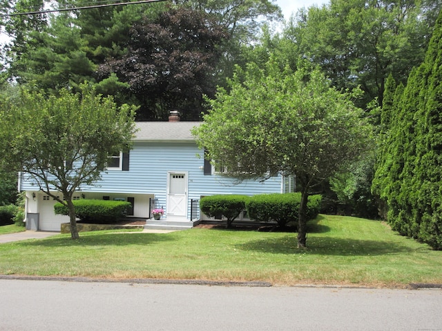 11 Ledgewood Dr, Ledyard, CT 06335 - split foyer home featuring a front yard, a garage, a chimney, and driveway