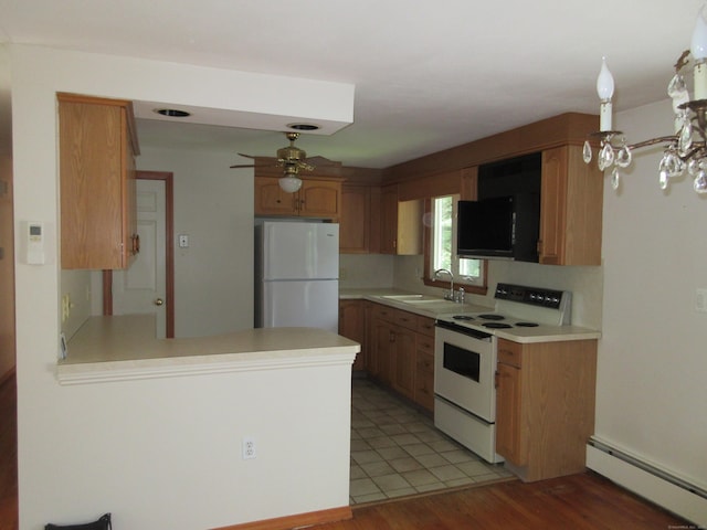 11 Ledgewood Dr, Ledyard, CT 06335 - kitchen with white appliances, a baseboard radiator, a ceiling fan, light countertops, and a peninsula