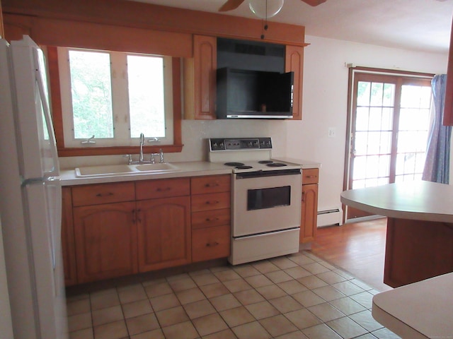 11 Ledgewood Dr, Ledyard, CT 06335 - kitchen with white appliances, baseboard heating, light countertops, and plenty of natural light