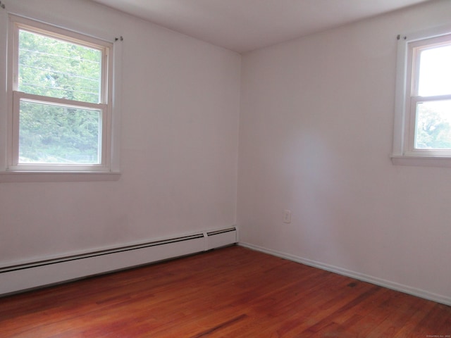 11 Ledgewood Dr, Ledyard, CT 06335 - spare room featuring a baseboard heating unit and wood finished floors