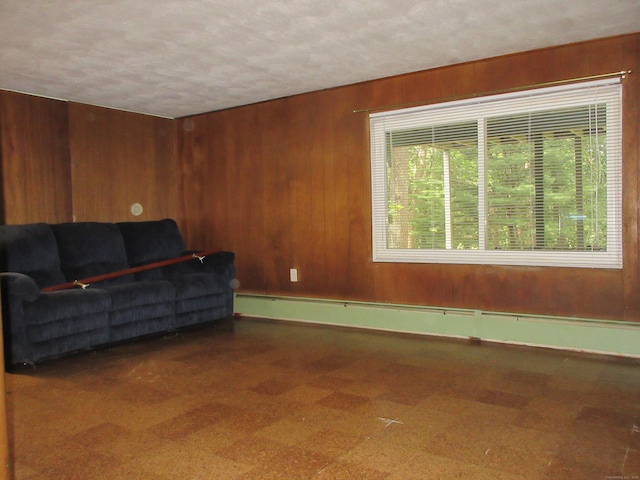 11 Ledgewood Dr, Ledyard, CT 06335 - sitting room with a baseboard radiator, wood walls, tile patterned floors, and a textured ceiling