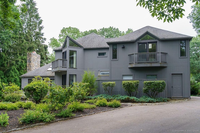 19 Money Point Rd, Stonington, CT 06355 - view of front of property with a balcony, roof with shingles, and a chimney