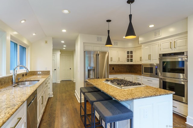 19 Money Point Rd, Stonington, CT 06355 - kitchen with appliances with stainless steel finishes, light stone countertops, a kitchen island, dark wood finished floors, and recessed lighting