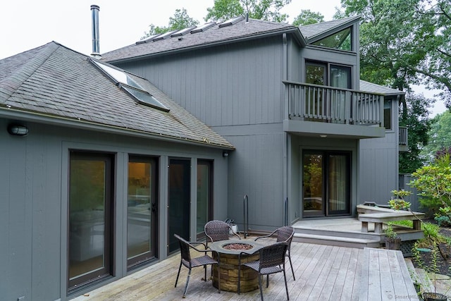 19 Money Point Rd, Stonington, CT 06355 - rear view of property with a balcony, roof with shingles, a fire pit, and a wooden deck