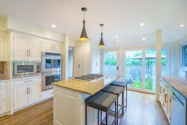 19 Money Point Rd, Stonington, CT 06355 - kitchen featuring stainless steel appliances, wood finished floors, light stone counters, white cabinets, and recessed lighting