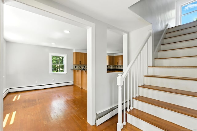 780 Park Ave, Windsor, CT 06095 - stairway with baseboard heating, a baseboard radiator, wood finished floors, and recessed lighting