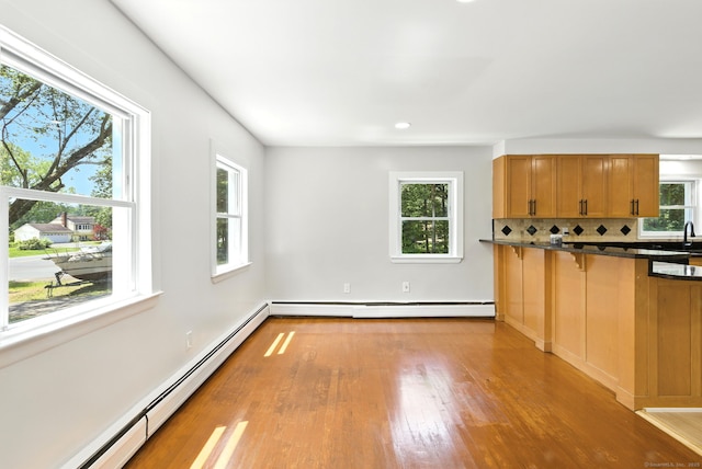 780 Park Ave, Windsor, CT 06095 - kitchen with a baseboard heating unit, a baseboard radiator, light wood-style floors, tasteful backsplash, and brown cabinetry