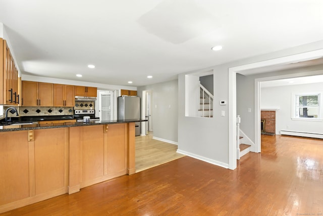 780 Park Ave, Windsor, CT 06095 - kitchen featuring stainless steel appliances, light wood finished floors, a peninsula, a baseboard heating unit, and recessed lighting