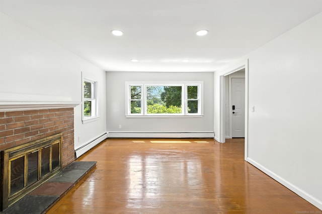 780 Park Ave, Windsor, CT 06095 - unfurnished living room with wood-type flooring, a brick fireplace, recessed lighting, and a baseboard radiator