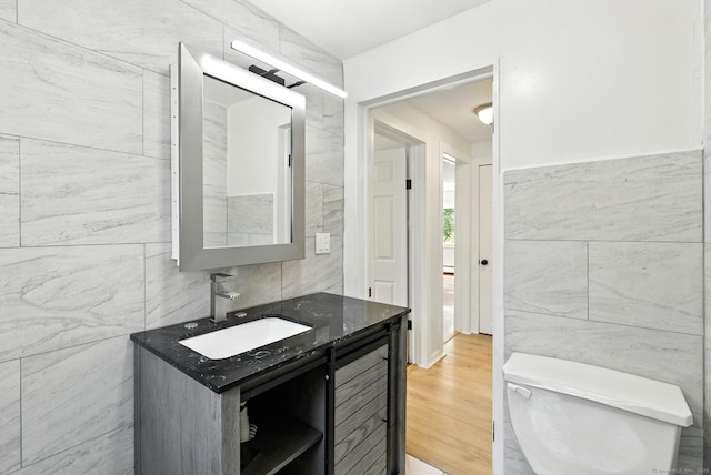 780 Park Ave, Windsor, CT 06095 - half bath with tile walls, vanity, and wood finished floors