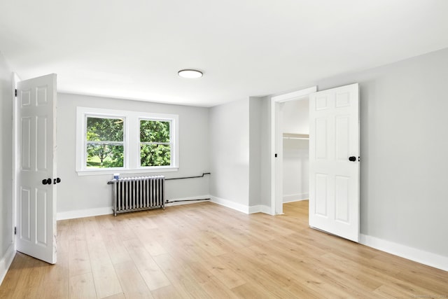 780 Park Ave, Windsor, CT 06095 - spare room featuring radiator heating unit and light wood-style floors