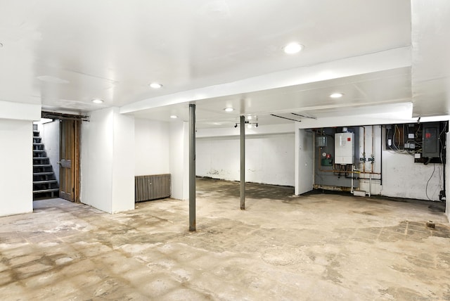 780 Park Ave, Windsor, CT 06095 - finished below grade area featuring tankless water heater, stairs, radiator heating unit, electric panel, and recessed lighting