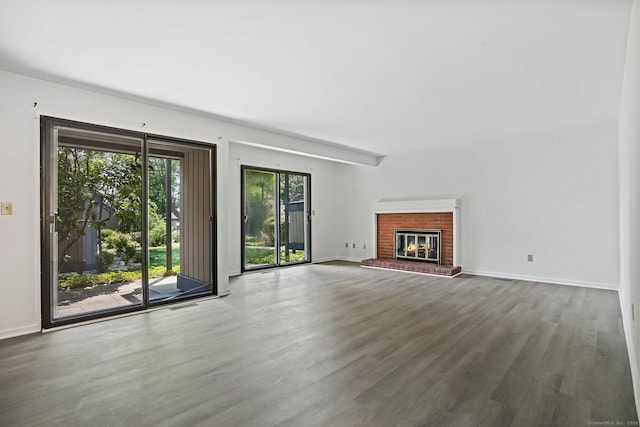 241 Heritage Vlg Unit C, Southbury, CT 06488 - unfurnished living room featuring wood finished floors and a fireplace