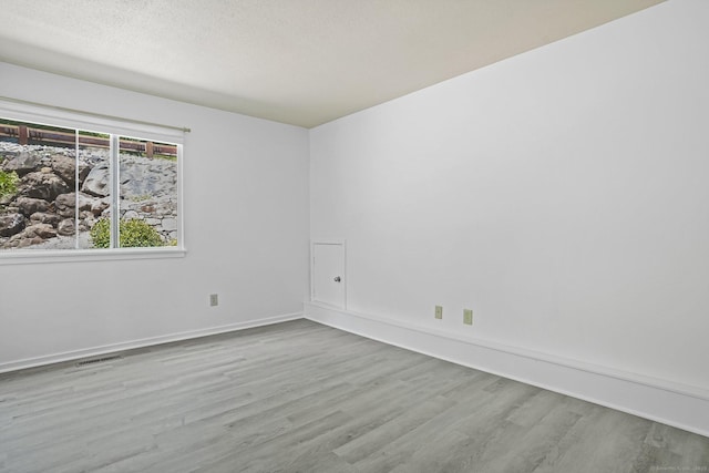 241 Heritage Vlg Unit C, Southbury, CT 06488 - spare room featuring wood finished floors and a textured ceiling