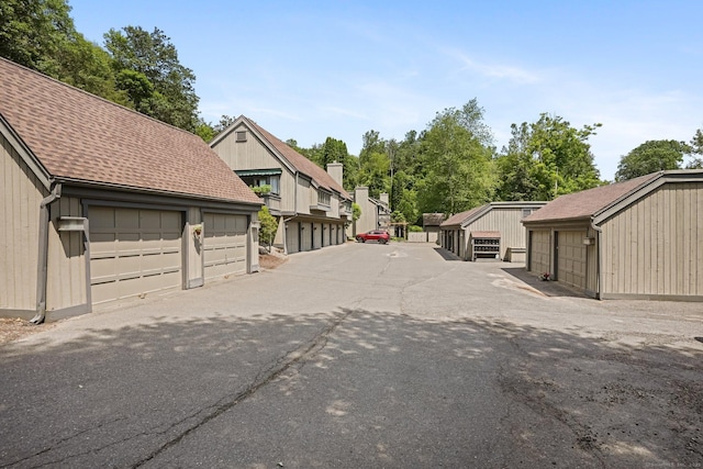 241 Heritage Vlg Unit C, Southbury, CT 06488 - view of asphalt road with community garages