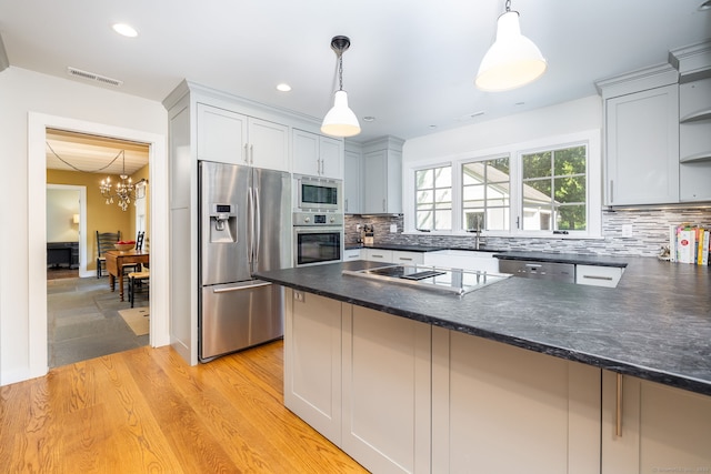 101 Tallmadge Ln, Litchfield, CT 06759 - kitchen with stainless steel appliances, a peninsula, backsplash, hanging light fixtures, and recessed lighting