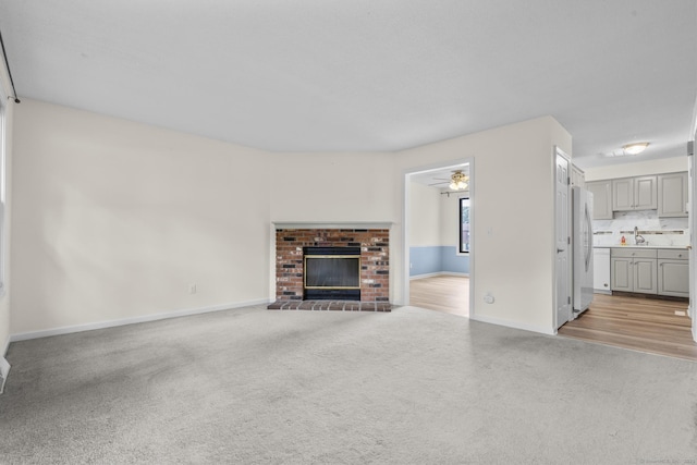 11 Bay Path Way Unit 11, Branford, CT 06405 - unfurnished living room with light colored carpet, a fireplace, and a ceiling fan