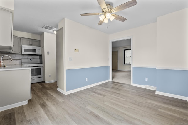 11 Bay Path Way Unit 11, Branford, CT 06405 - kitchen with white appliances, gray cabinets, ceiling fan, light countertops, and light wood finished floors