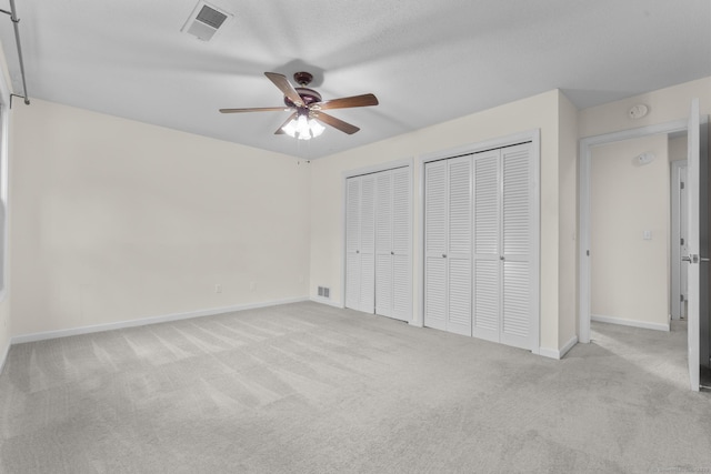 11 Bay Path Way Unit 11, Branford, CT 06405 - unfurnished bedroom featuring multiple closets, carpet flooring, and ceiling fan