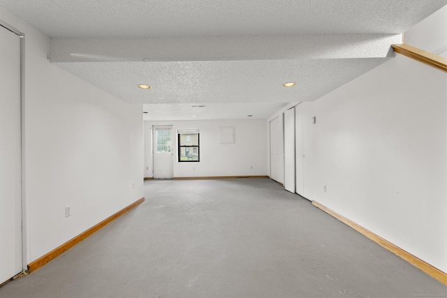 11 Bay Path Way Unit 11, Branford, CT 06405 - empty room with finished concrete flooring, a textured ceiling, and recessed lighting