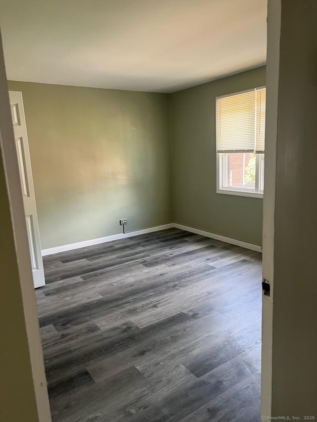 401 Granfield Ave Unit C Bldg 2, Bridgeport, CT 06610 - unfurnished room with dark wood-style flooring and baseboards